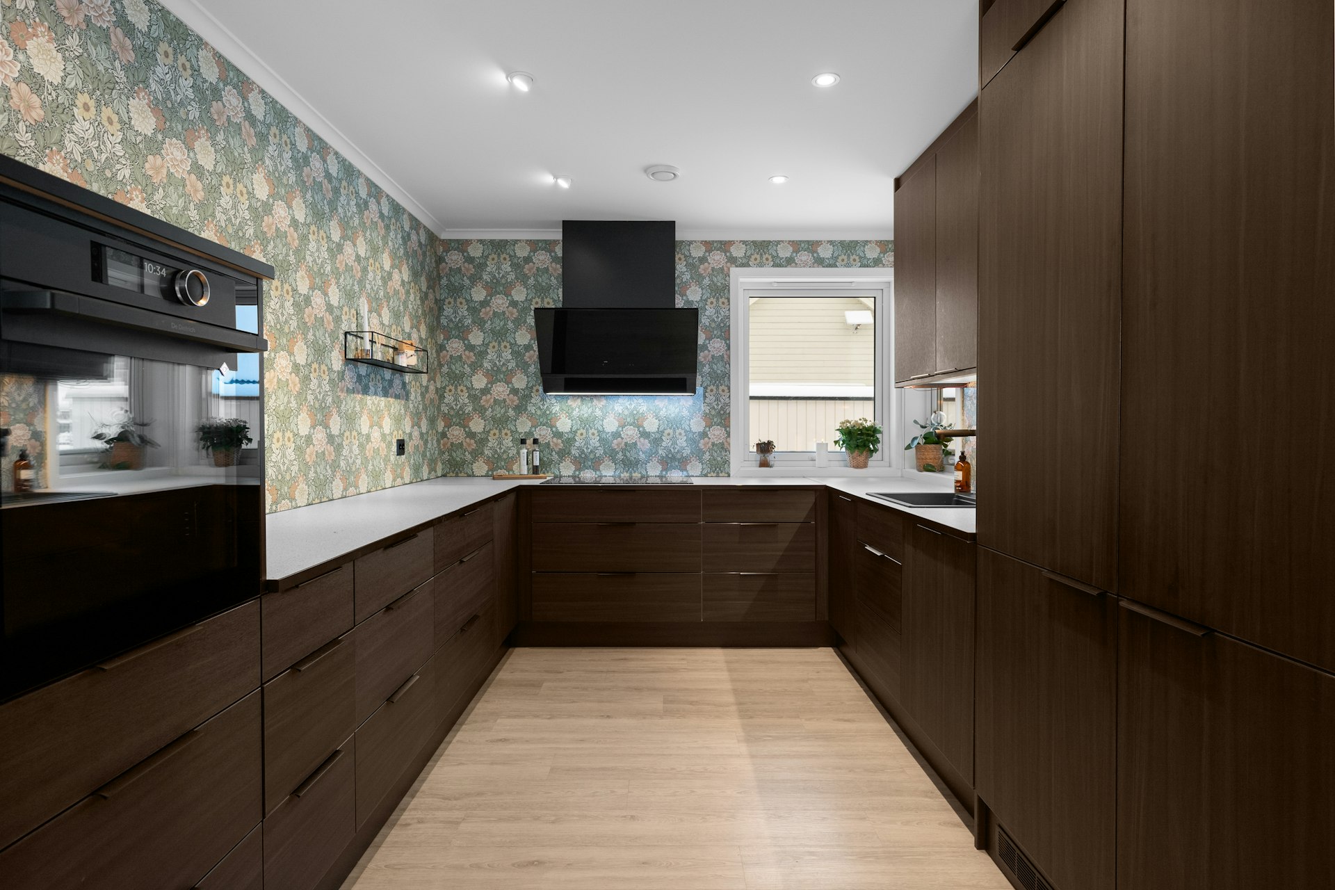 A kitchen with wooden cabinets and a white counter top